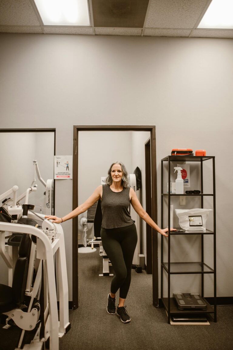 Confident senior woman in fitness studio embracing wellness and empowerment.